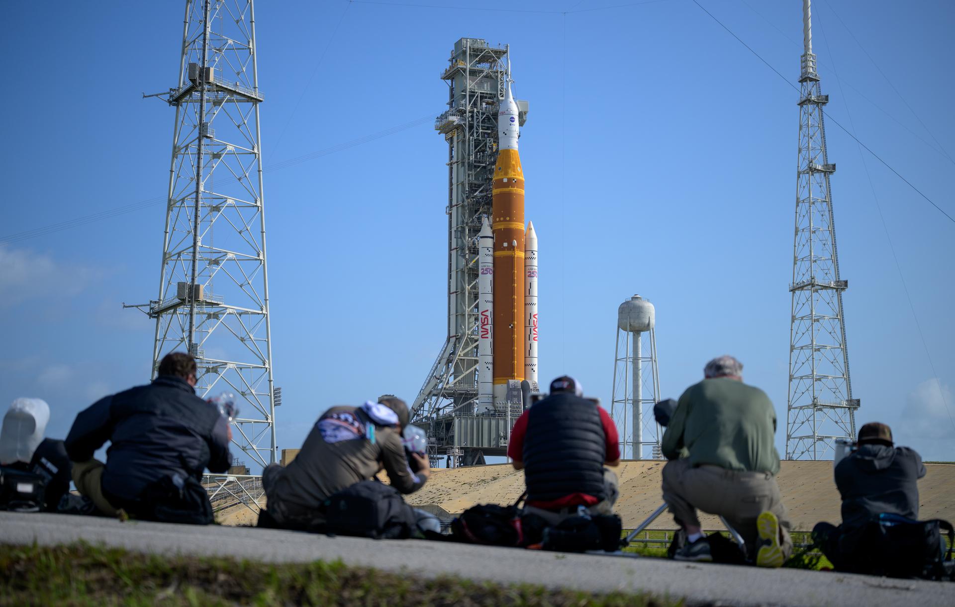 Heavy-lift rocket on a launch pad at dusk